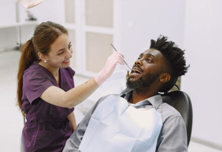 Manchester dentist doing dental cleaning to patient