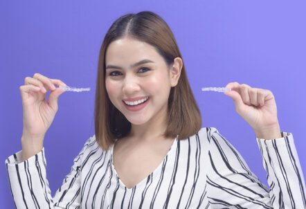 Girl holding clear Aligner
